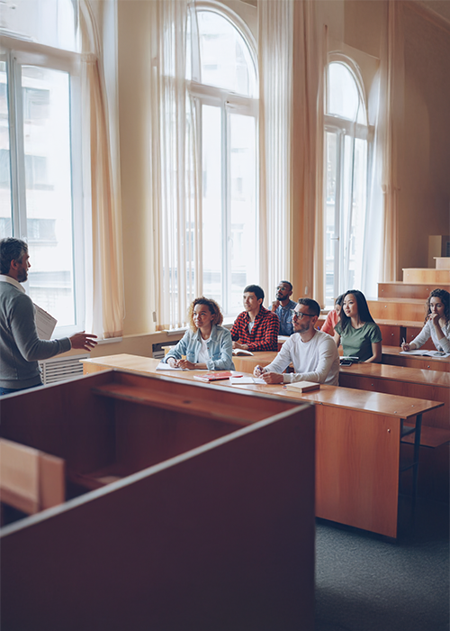Professor lectures to students in a classroom setting.